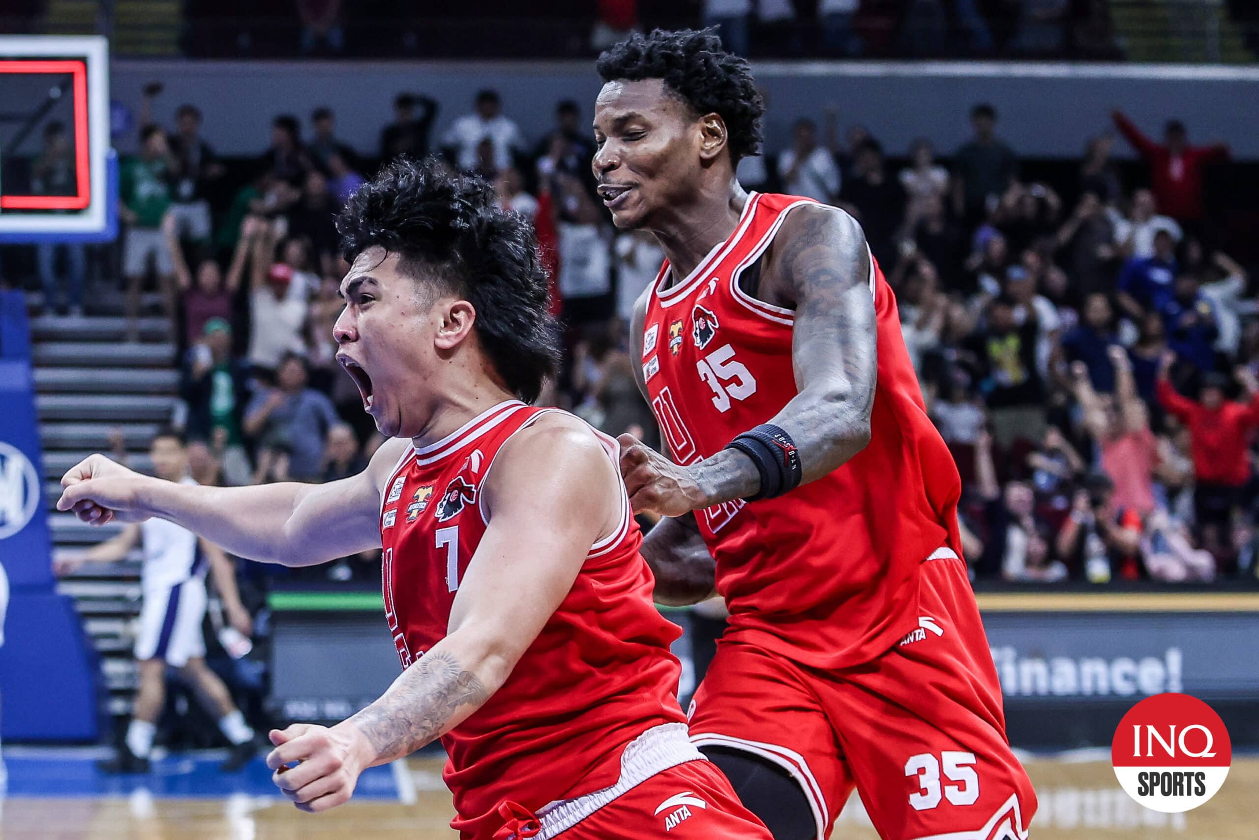 UE Red Warriors' Wello Lingolingo and Precious Momowei celebrate after a win over Adamson Falcons in the UAAP Season 87 men's basketball tournament