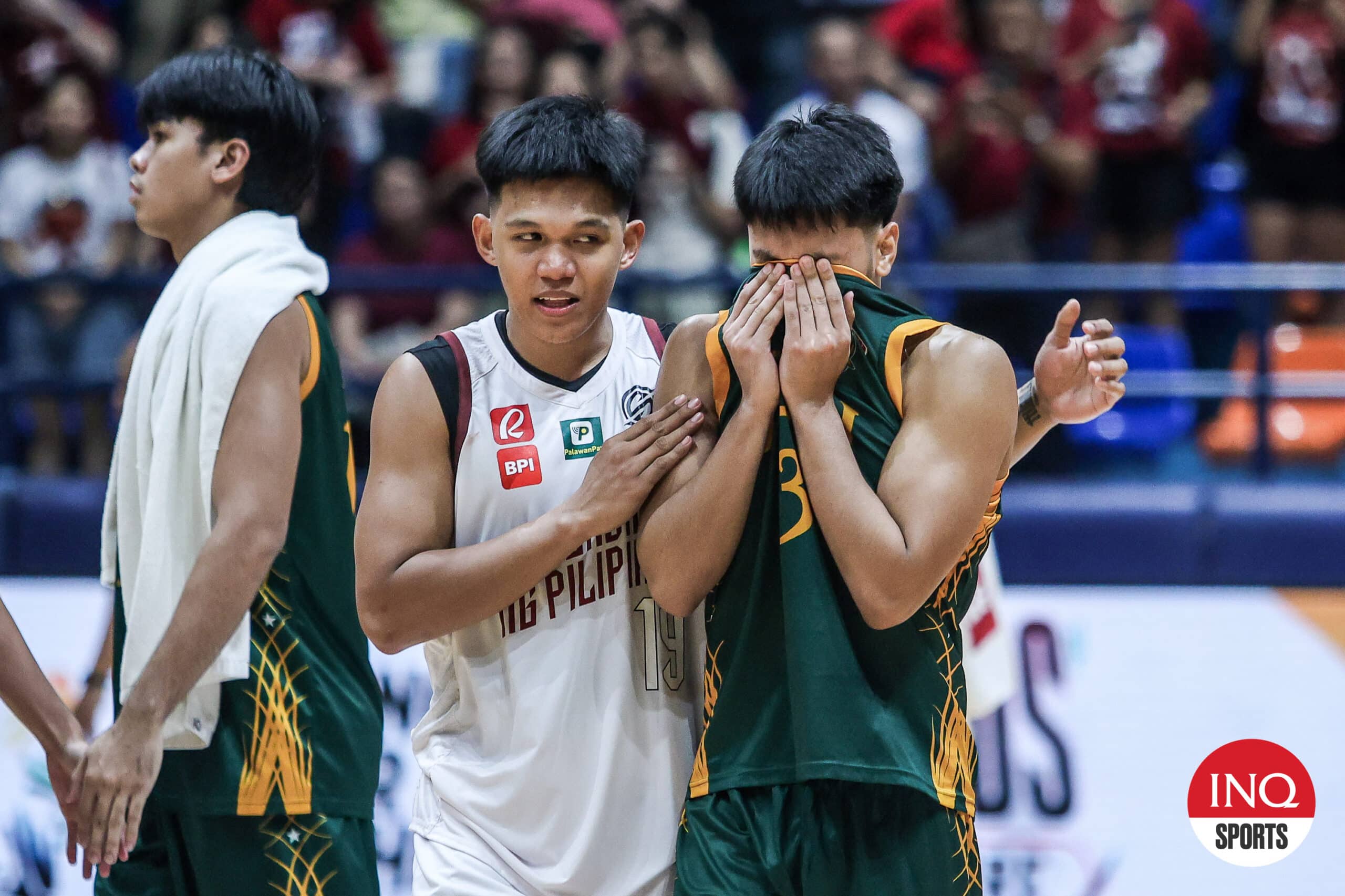 UP Fighting Maroons' Gerry Abadiano comforts FEU's Jorick Bautista after a UAAP Season 87 men's basketball game.