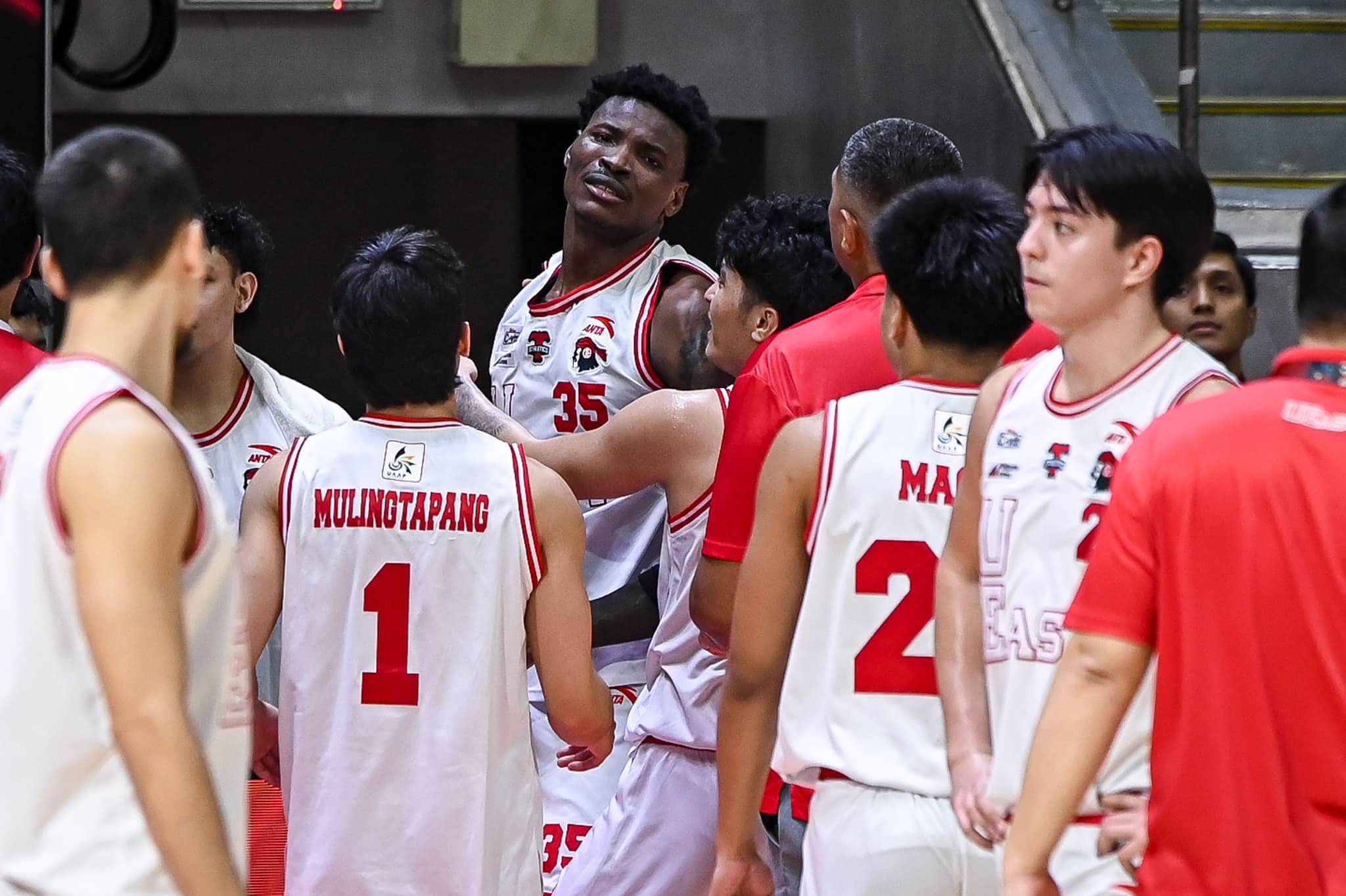 UE Red Warriors' Precious Momowei reacts after an incident during a UAAP Season 87 men's basketball game against the UST Growling TIgers.