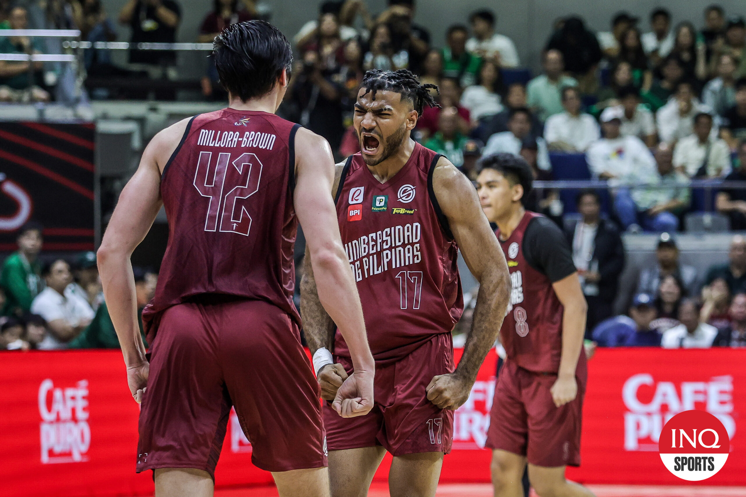 Francis Lopez and Quentin Millora-Brown celebrate a play in Game 1 of the UAAP Season 87 men's basketball Finals between La Salle Green Archers and UP Fighting Maroons.