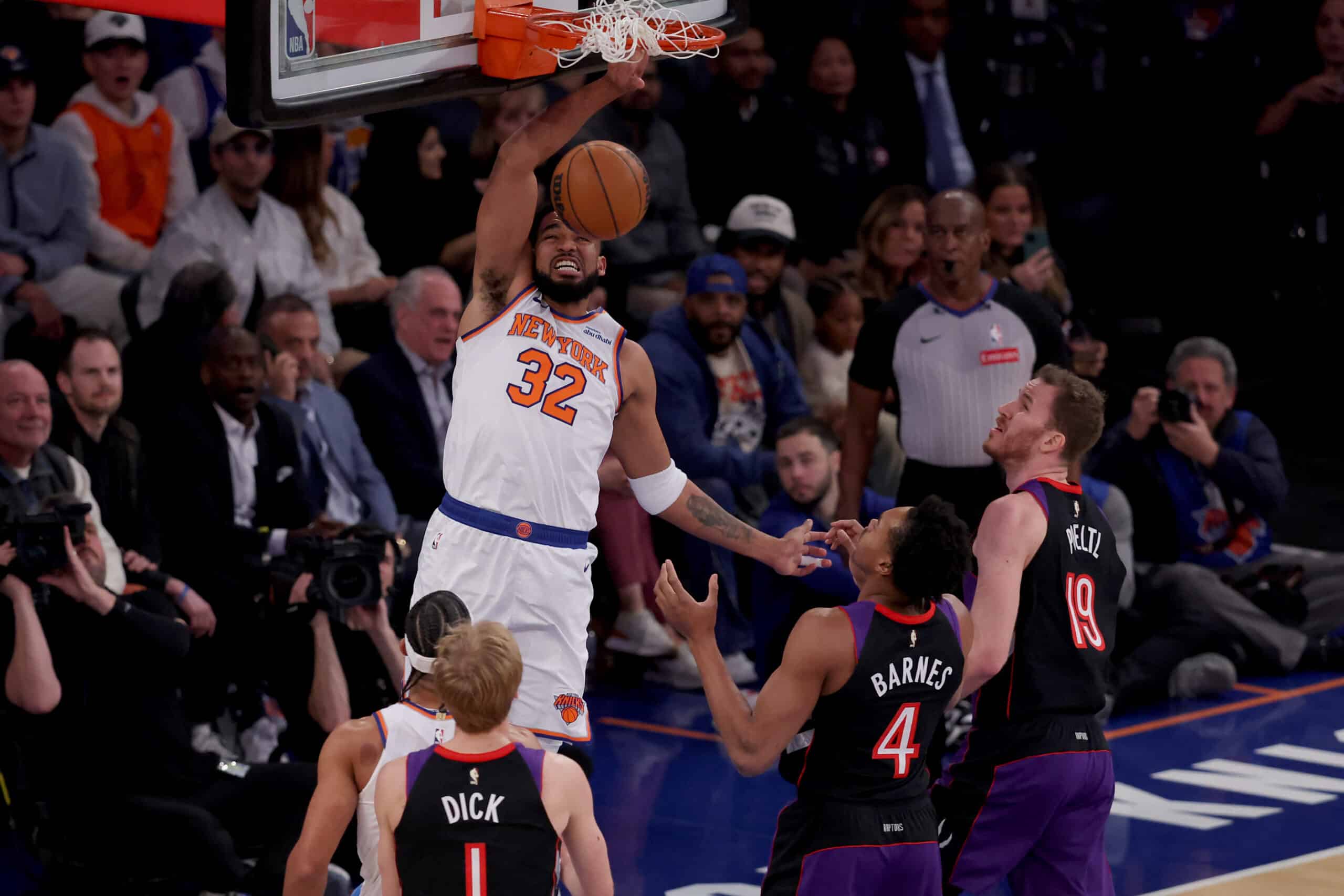 New York Knicks center Karl-Anthony Towns (32) dunks against Toronto Raptors guard Gradey Dick NBA