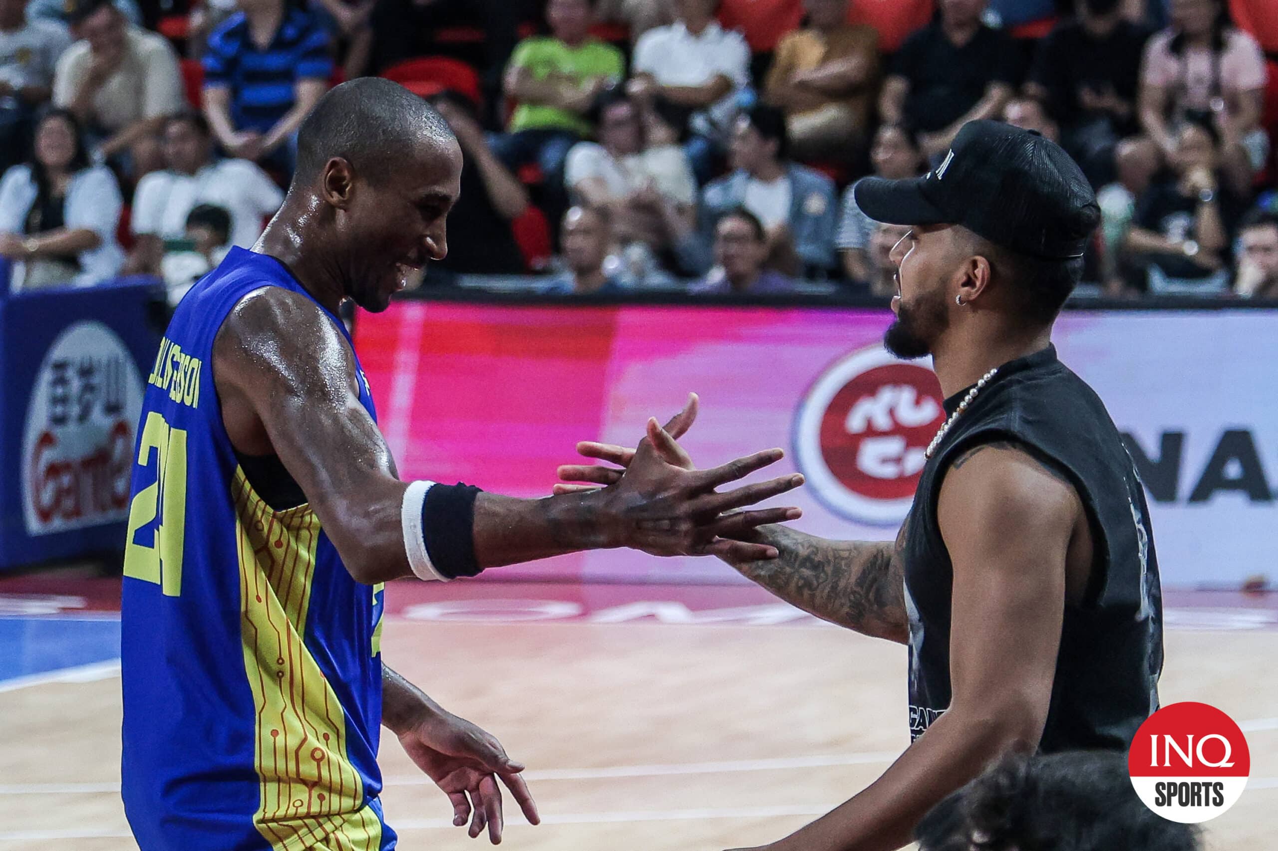 TNT import Rondae Hollis Jefferson and former star Mikey Williams exchange greetings during a PBA Commissioner's Cup game.