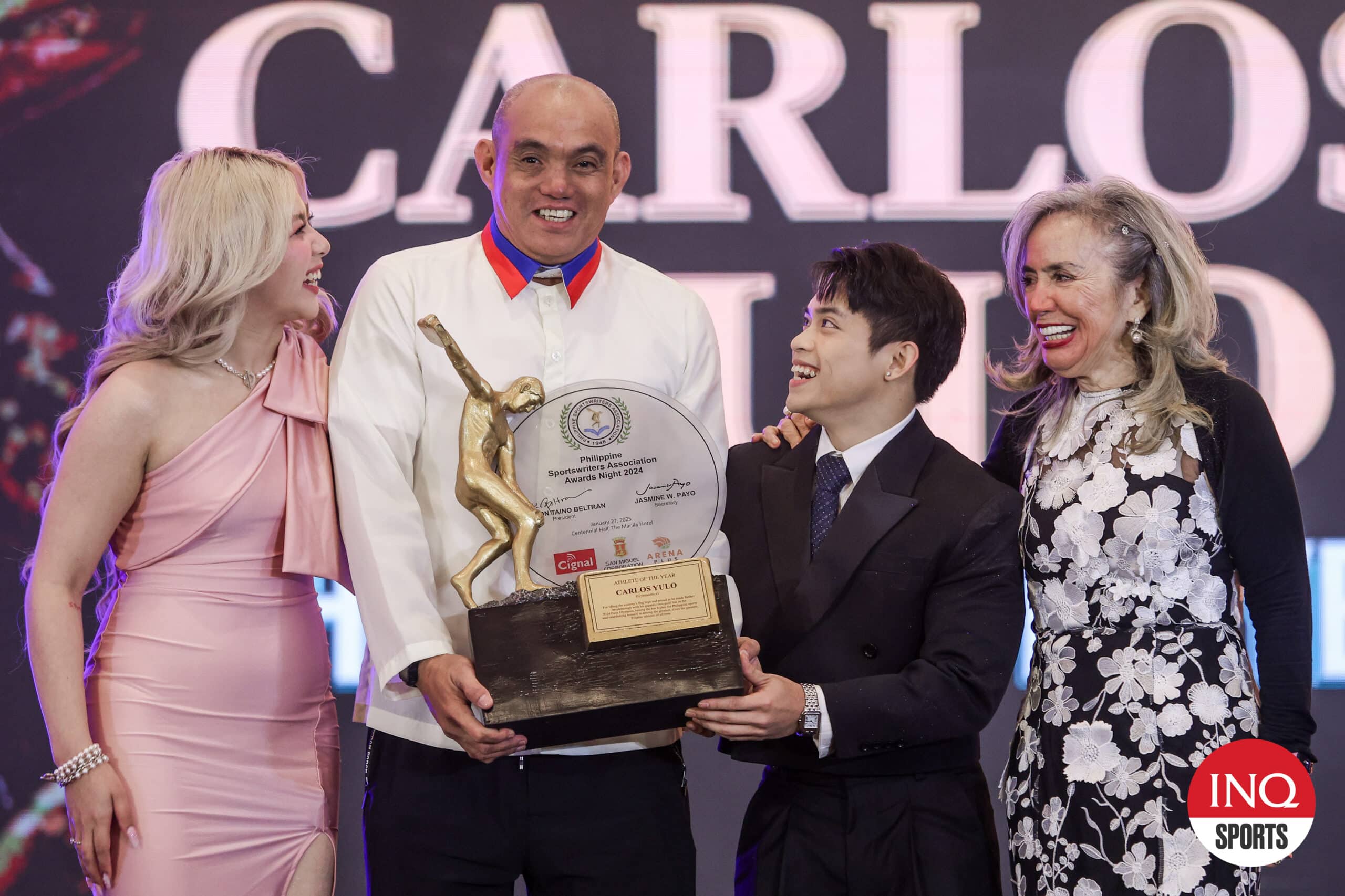 Carlos Yulo, the Philippines' first and only double gold medalist in the Olympics, receives his Athlete of the Year award from the Philippine Sportswriters Association (PSA) during its awards night on Monday at Manila Hotel. He is with his girlfriend Chloe, coach Allen Aldrin Castañeda and GAP president Cynthia Carreon.