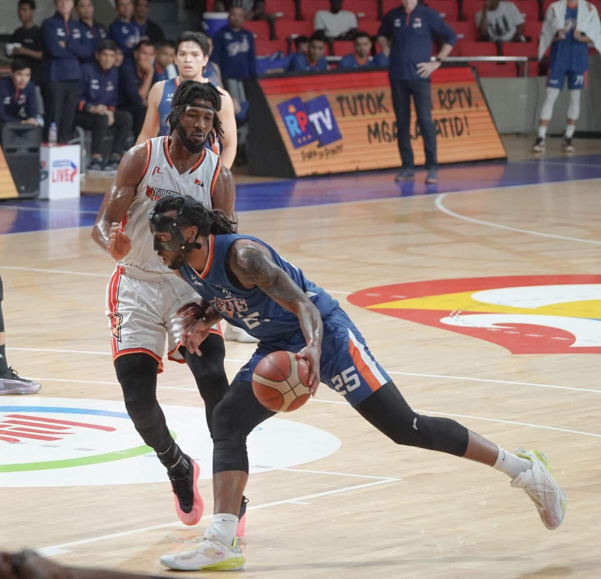 Akil Mitchell of Meralco (with ball) drives hard against the defense of NorthPort’s Kadeem Jack.