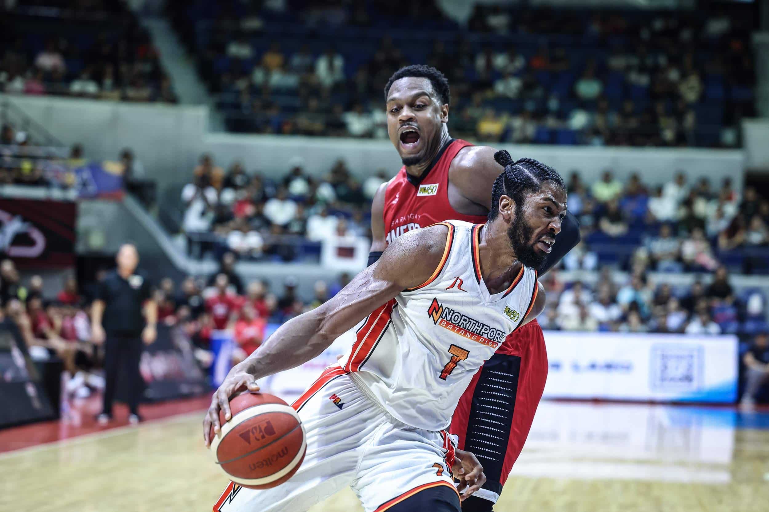 NorthPort import Kadeem Jack drives against Barangay Ginebra import Justin Brownlee during the PBA Commissioner's Cup semifinals.