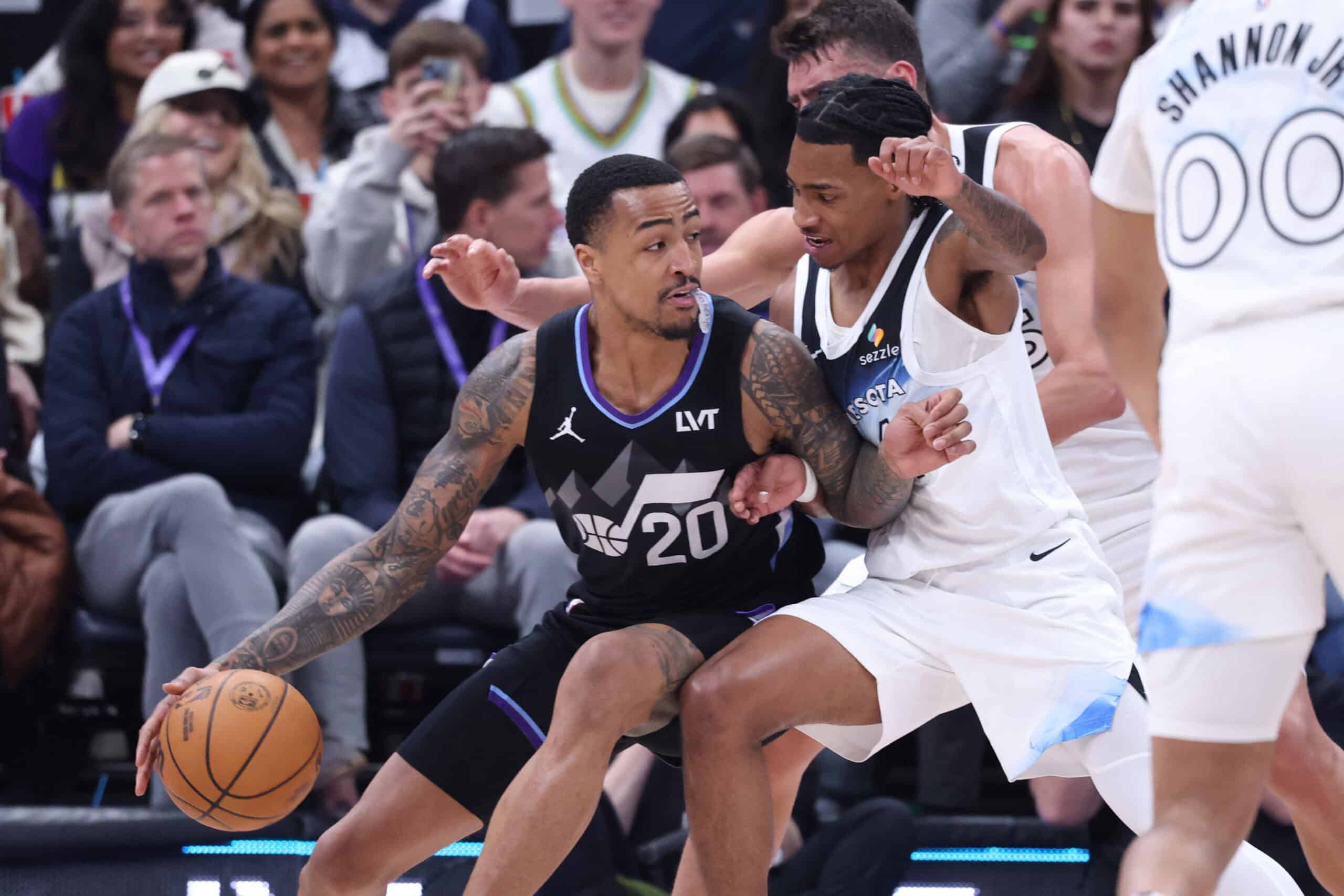 Feb 28, 2025; Salt Lake City, Utah, USA; Utah Jazz forward John Collins (20) dribbles the ball against Minnesota Timberwolves guard Rob Dillingham during the second half at Delta Center.  NBA