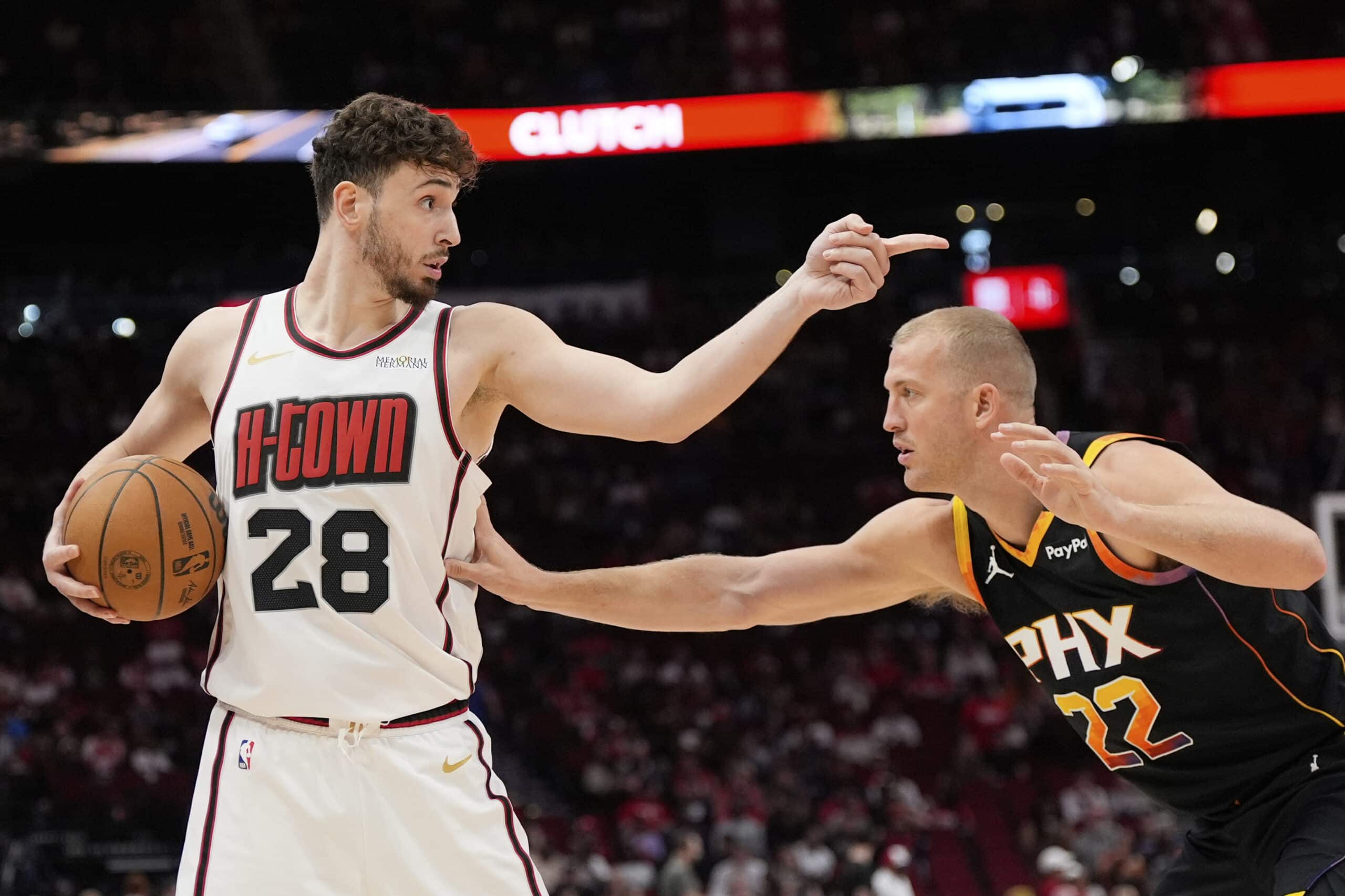 Houston Rockets' Alperen Sengun (28) points over Phoenix Suns' Mason Plumlee (22) during the first half of an NBA basketball game Wednesday, March 12, 2025, in Houston.