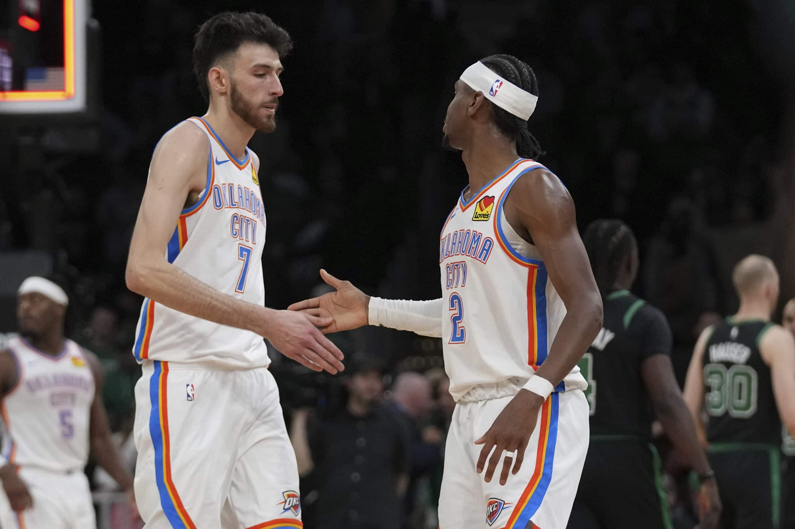 Oklahoma City Thunder forward Chet Holmgren (7) celebrates with Shai Gilgeous-Alexander, right, after defeating the Boston Celtics following an NBA basketball game, Wednesday, March 12, 2025, in Boston