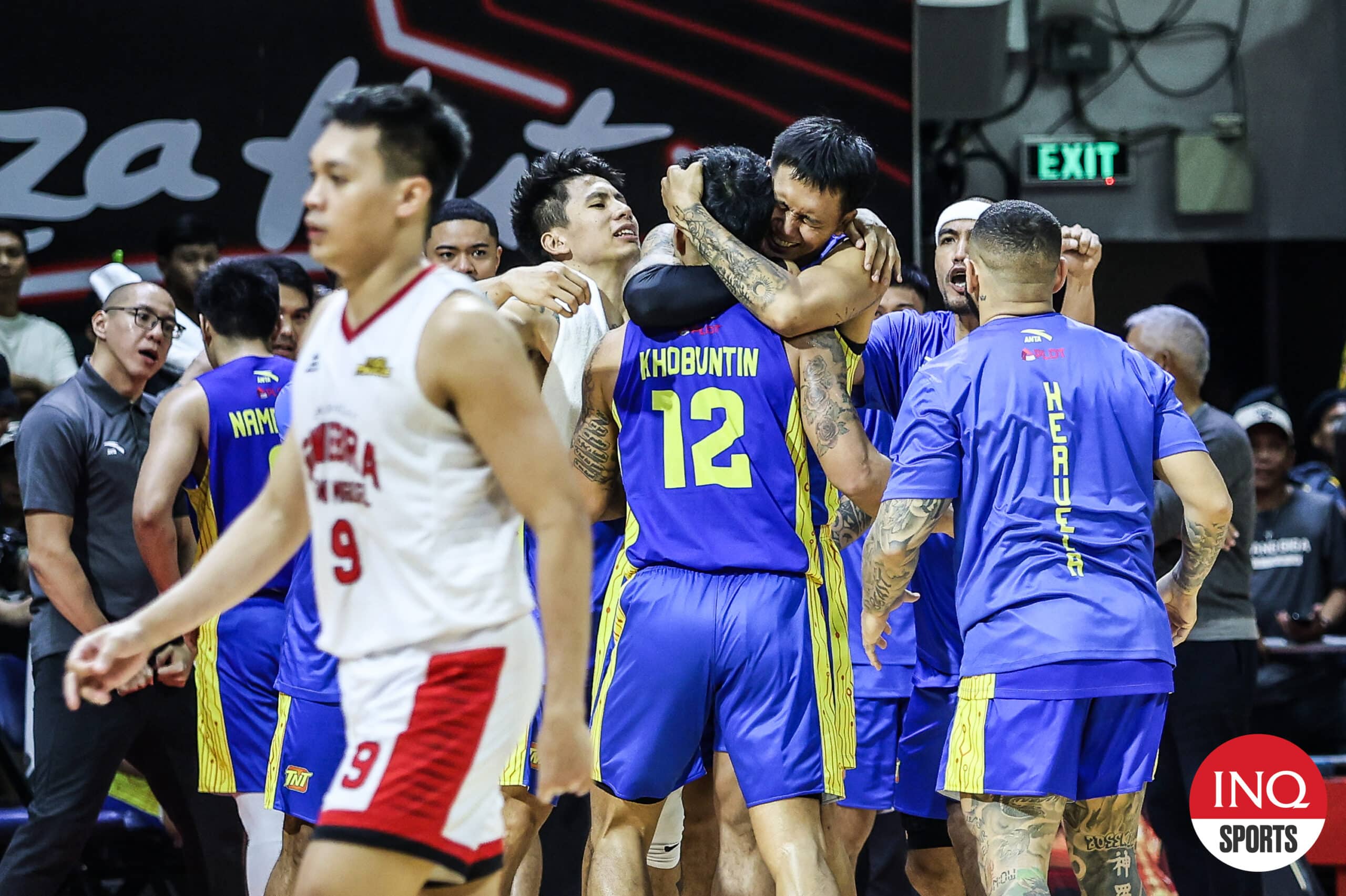 TNT players celebrate after a big shot by Glenn Khobuntin in Game 7 of the PBA Commissioner's Cup Finals against Barangay Ginebra Gin Kings.