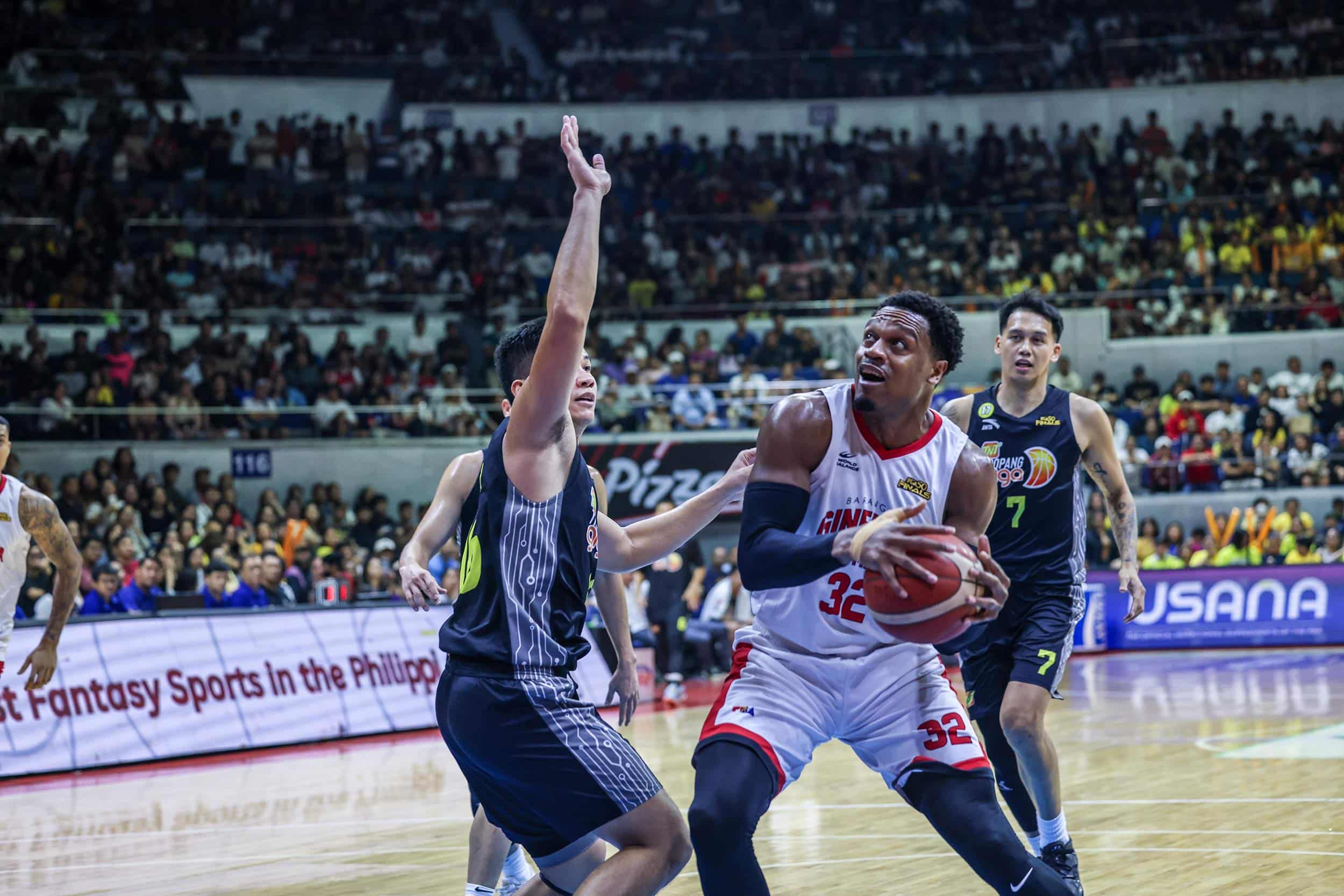 Barangay Ginebra's Justin Brownlee against TNT Tropang Giga's RR Pogoy during Game 5 of the PBA Commissioner's Cup Finals.