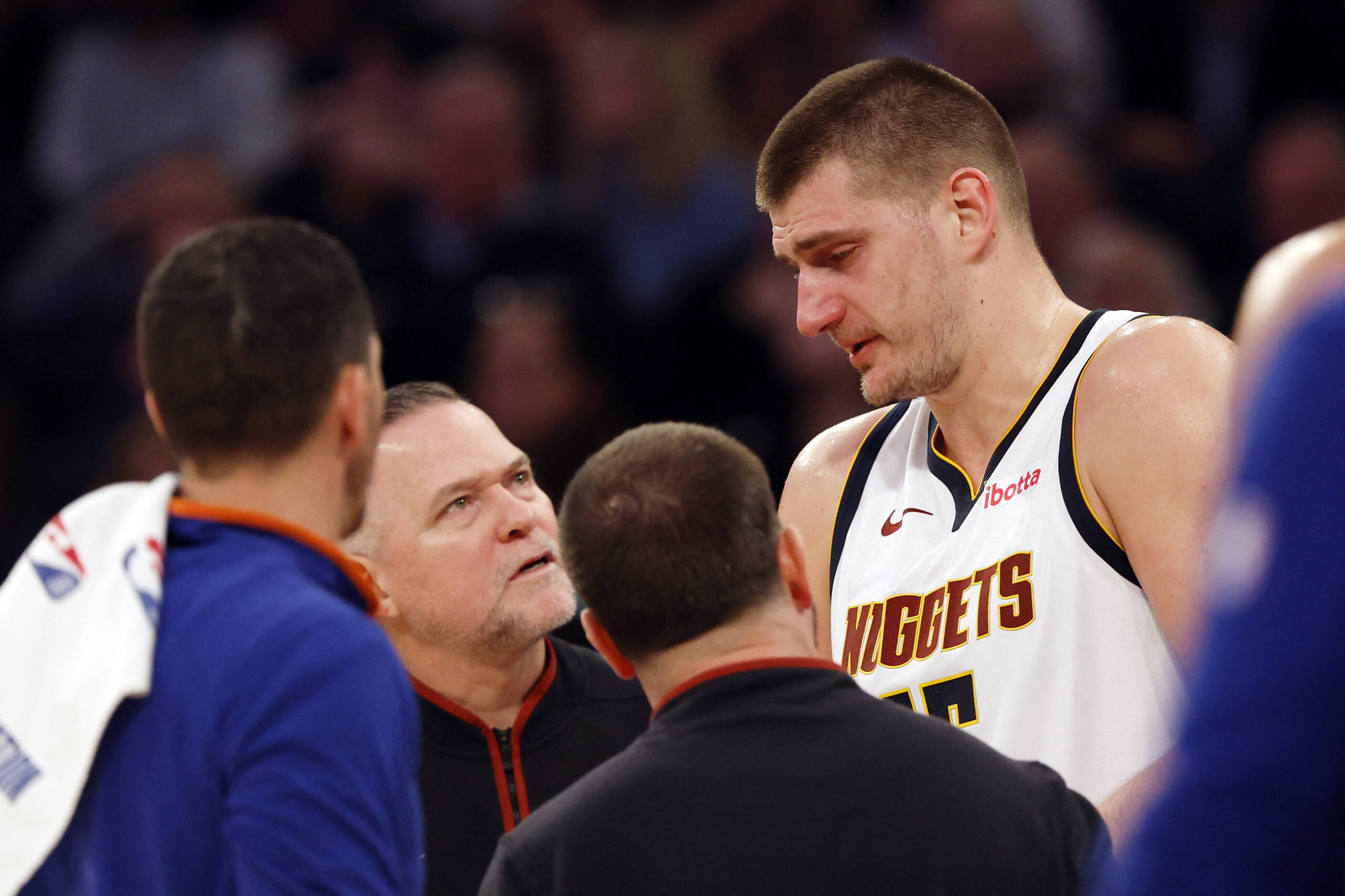 NBA Nikola Jokic #15 reacts with head coach Michael Malone of the Denver Nuggets