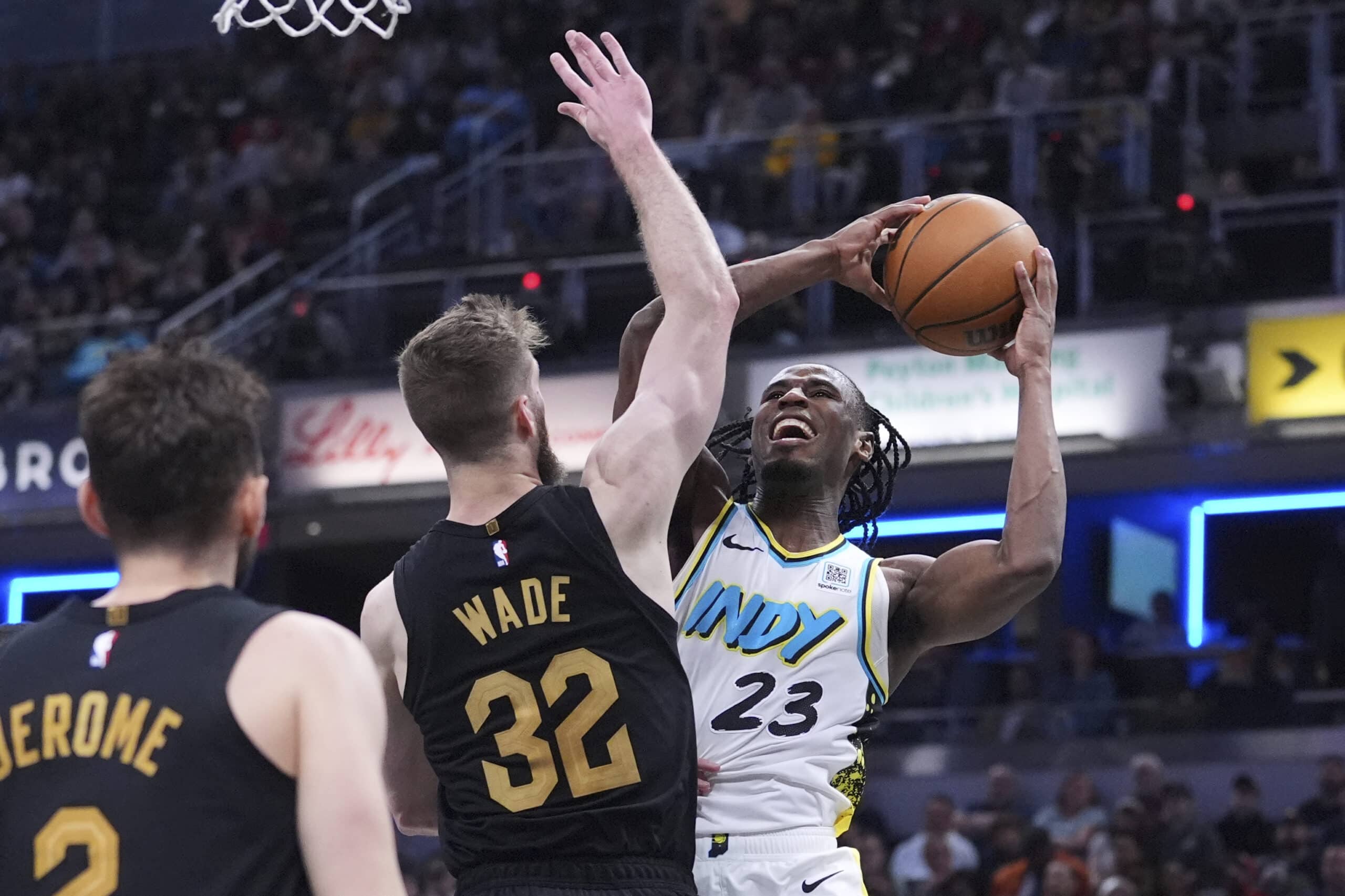 Indiana Pacers forward Aaron Nesmith (23) shoots over Cleveland Cavaliers forward Dean Wade (32) during the second half of an NBA basketball game in Indianapolis, Thursday, April 10, 2025.