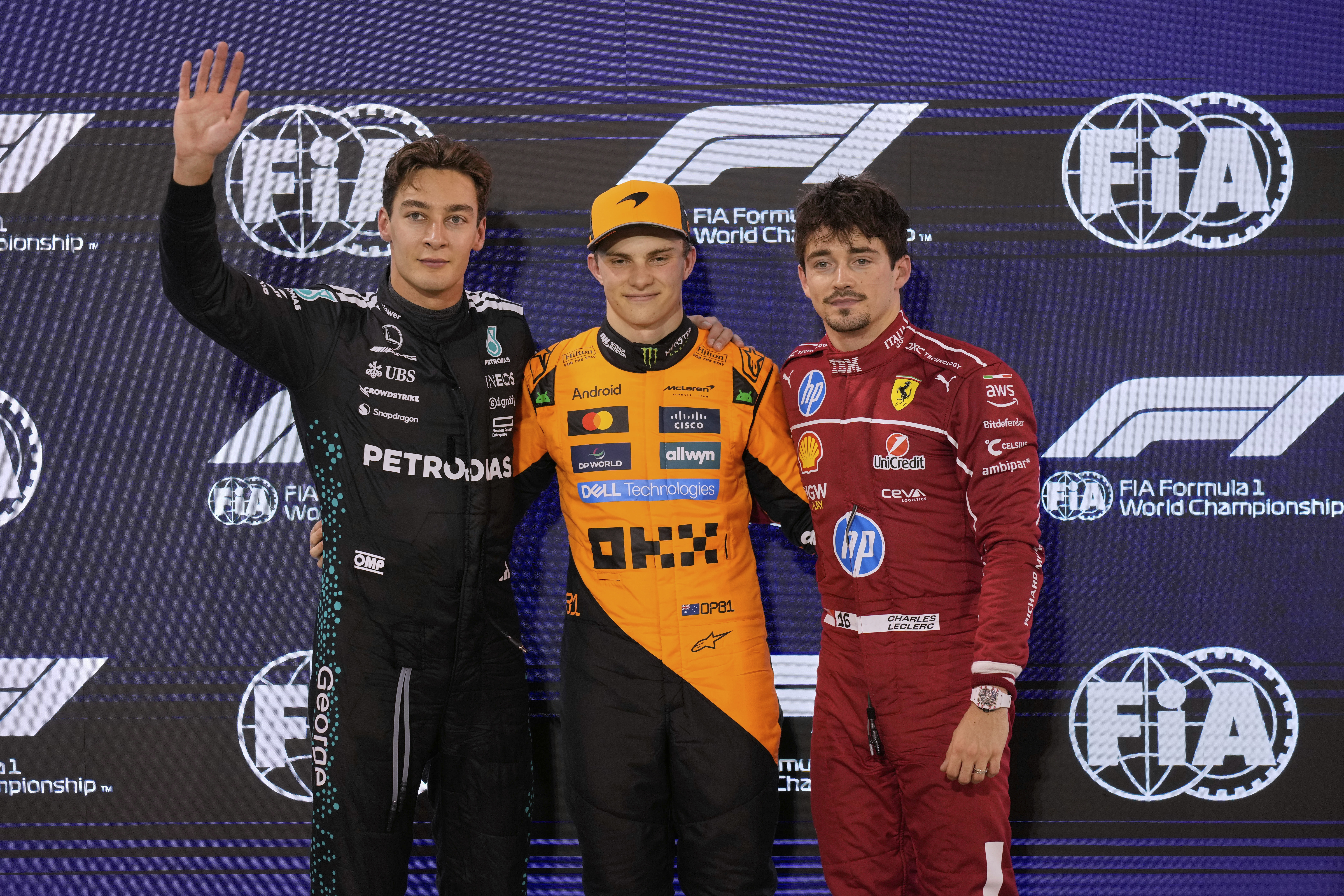Second placed Mercedes driver George Russell of Britain, left, first-placed McLaren driver Oscar Piastri of Australia, center, and thrid placed Ferrari driver Charles Leclerc of Monaco pose after the qualifying for the Formula One F1 2025 Bahrain Grand Prix,