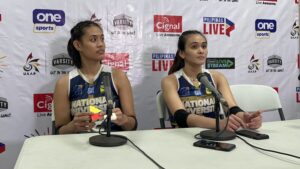Alyssa Solomon (left) fiddling with a Rubik's cube during a post-game interview with Bella Belen in the UAAP Season 86 women's volleyball tournament